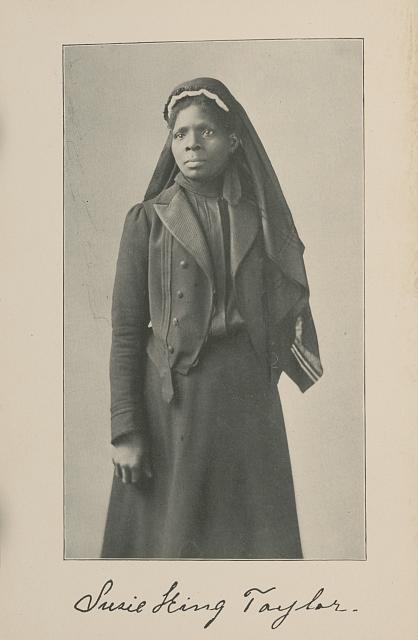3/4 body photo of Susie King Taylor standing and facing front.