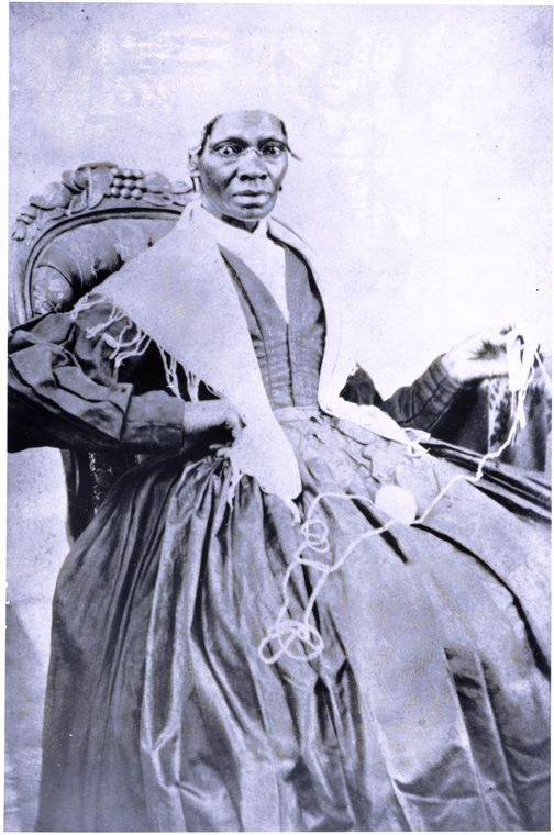 Sojourner Truth seated and facing front, She is holding yarn in one hand. 