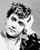 Head and neck photo of Adah Menken facing front with her head resting on her right hand.