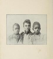 N. F. Mossell is sitting between her two daughters. All are facing front.