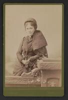 Sepia photograph of Hallie Quinn Brown standing, looking front.