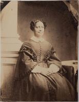 3/4 body photo of Sarah Parker Remond seated and facing front, her hands crossed in her lap.