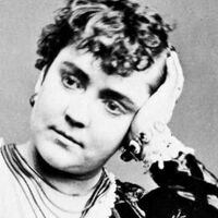 Head and neck photo of Adah Menken facing front with her head resting on her right hand.