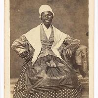 3/4 body photo of Sojourner Truth seated with a picture in her lap. 