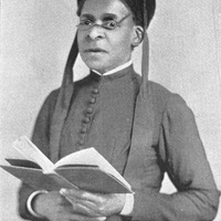 Julia A. J. Foote standing and holding an open book with both hands.
