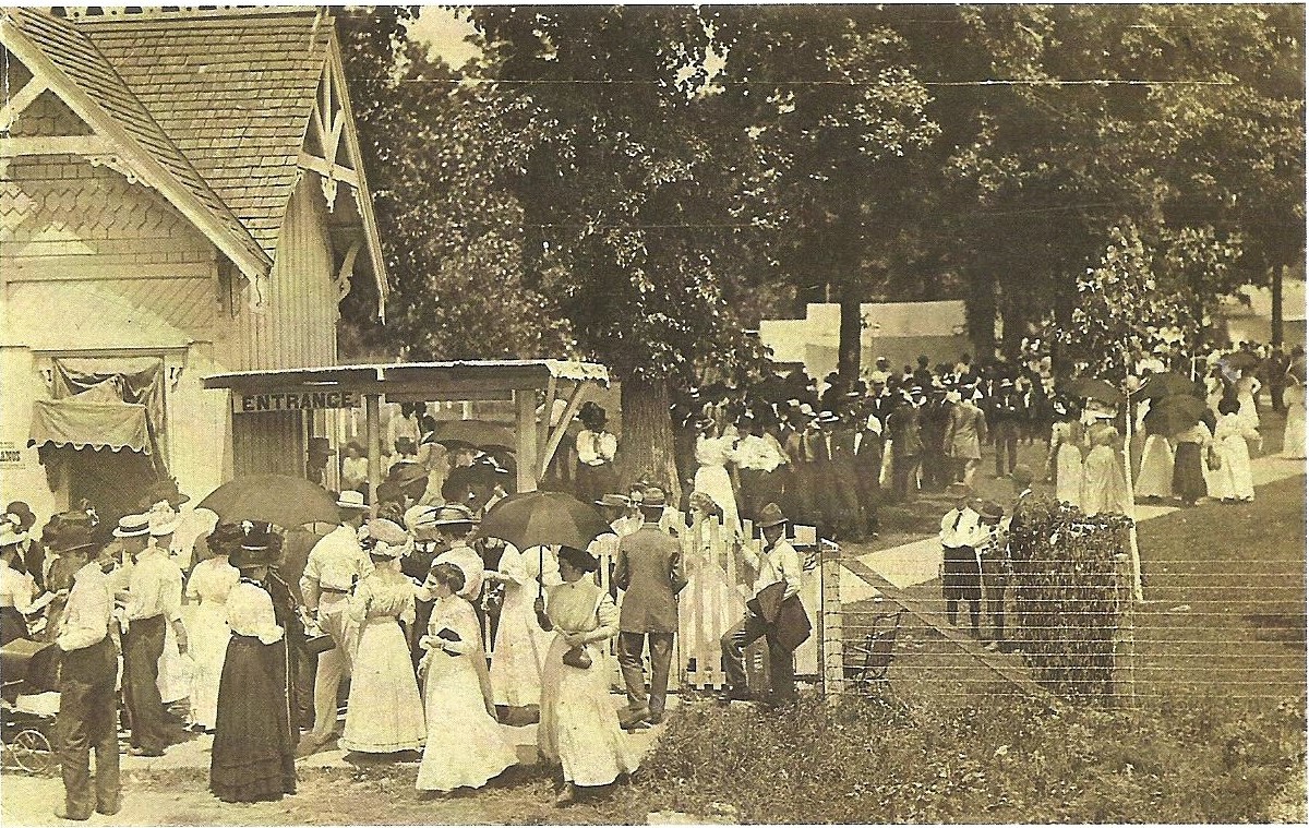 Photograph of crowd gathered near the entrance to the Shelbyville Chautauqua Auditorium grounds, early 20th century.