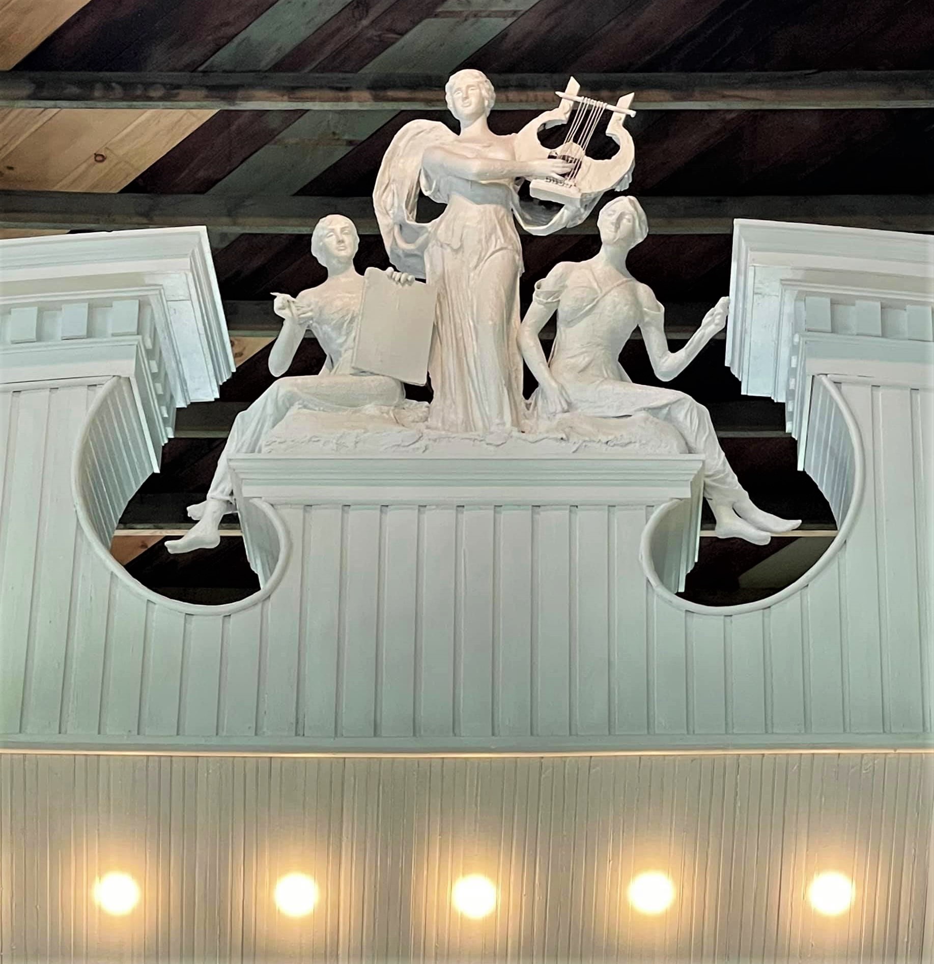 Photograph of sculpture by Robert Marshall Root at the apex of the proscenium of the Shelbyville Chautauqua Auditorium stage.