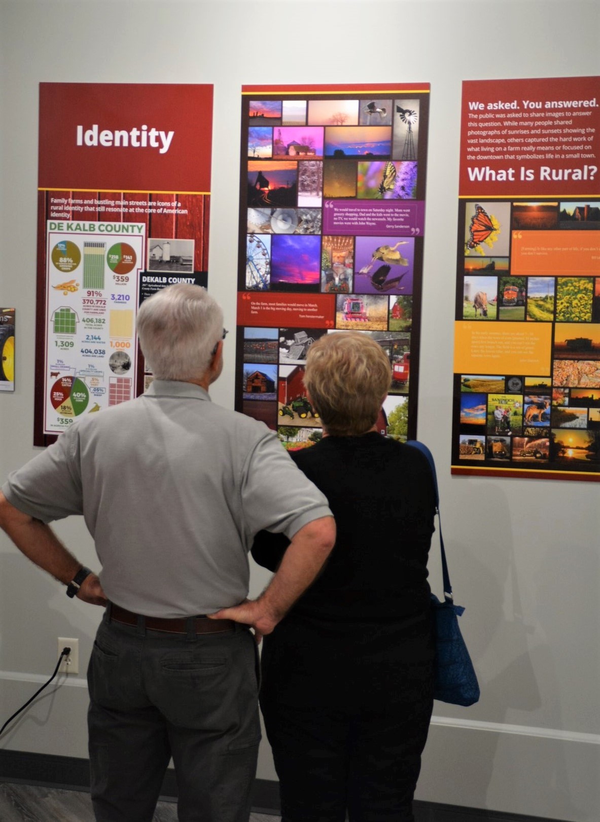 Photograph of visitors to DeKalb County History Center viewing the “Identity” section of the center’s Crossroads companion exhibition.