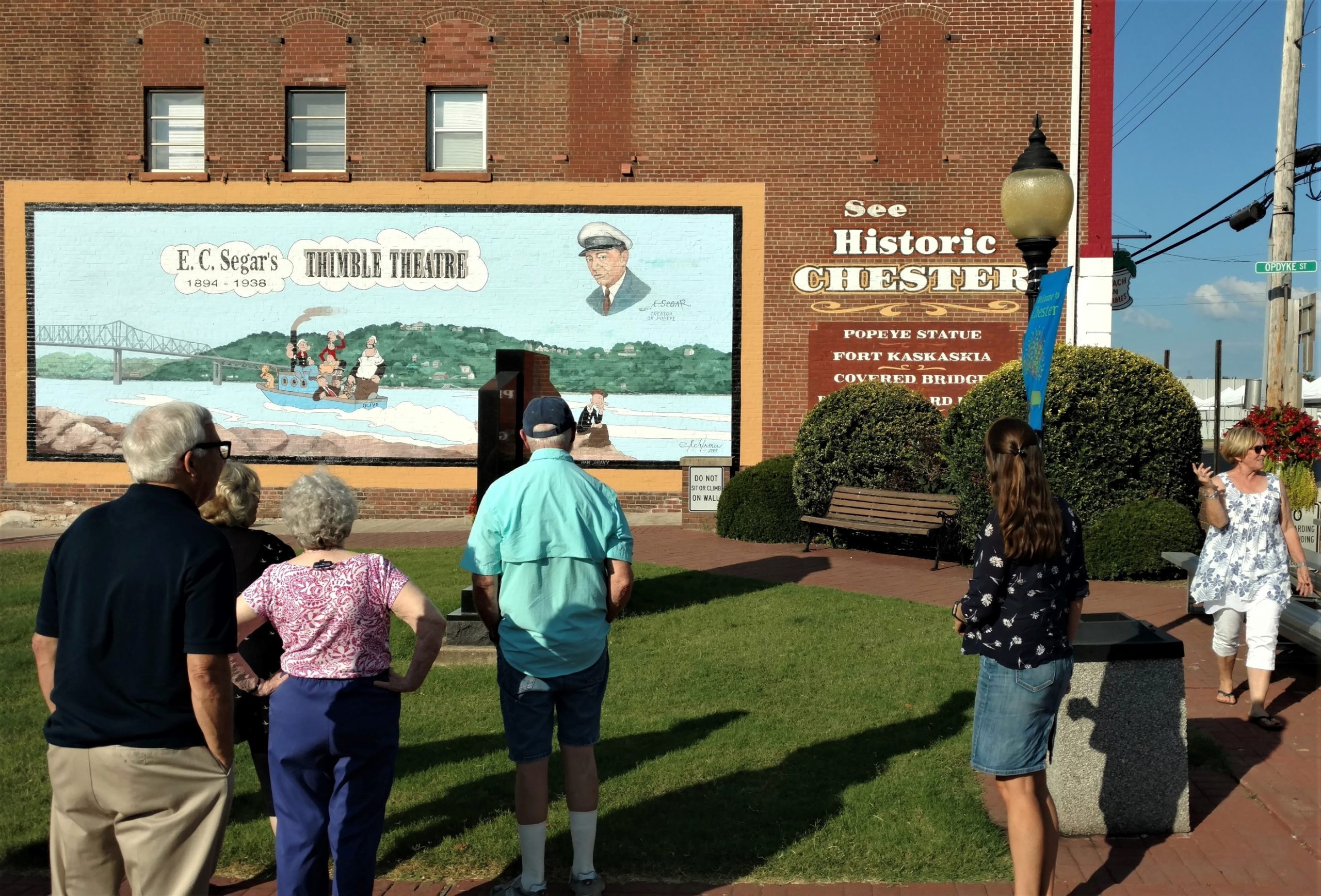 Photograph of participants in the Crossroads installation workshop viewing Popeye mural, Chester, Illinois.