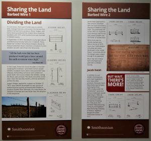Photograph of a segment of DeKalb County History Center's companion exhibition discussing barbed wire, including images and text.