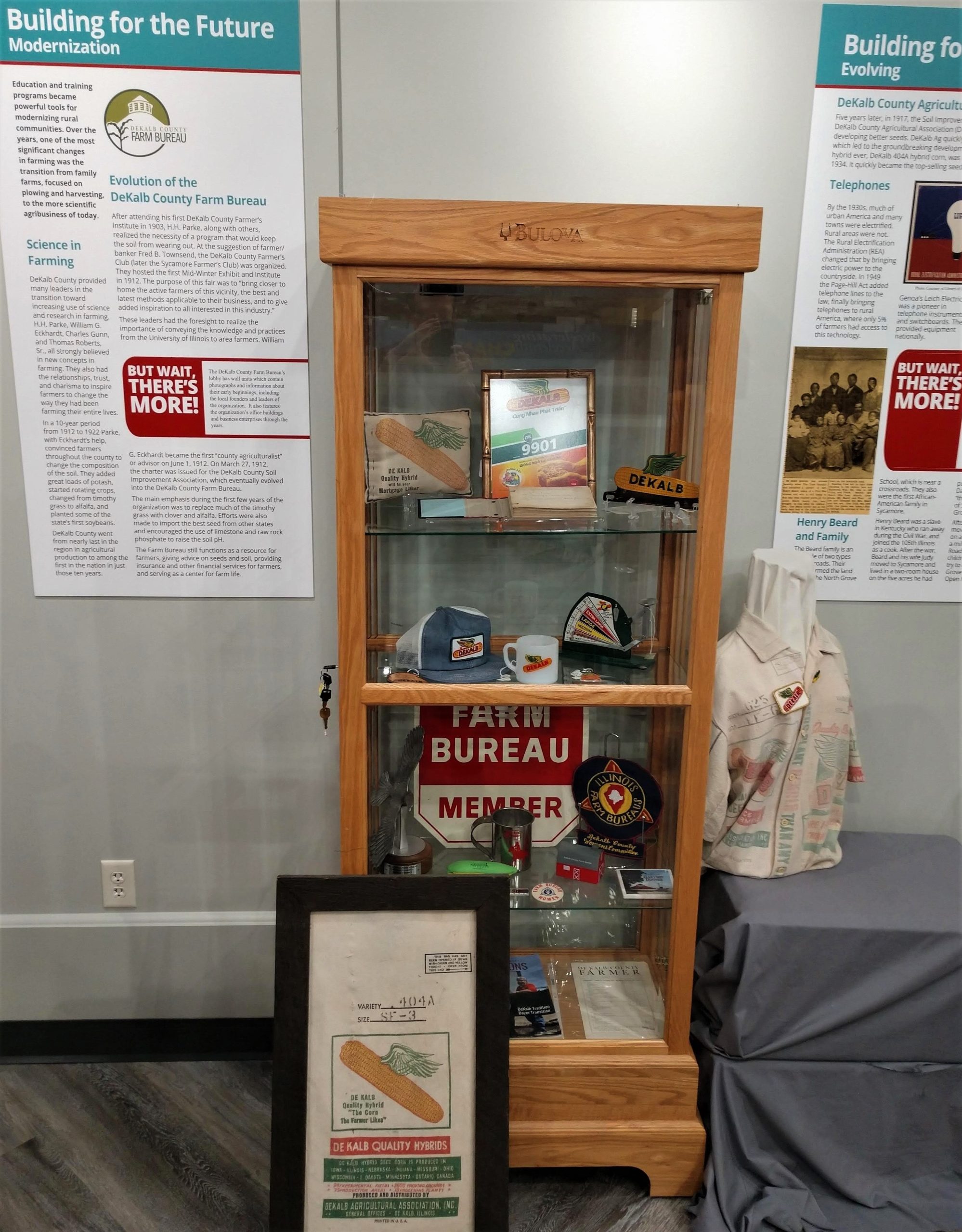 Photograph of a segment of DeKalb County History Center's companion exhibition featuring DeKalb Ag-related memorabilia and information.