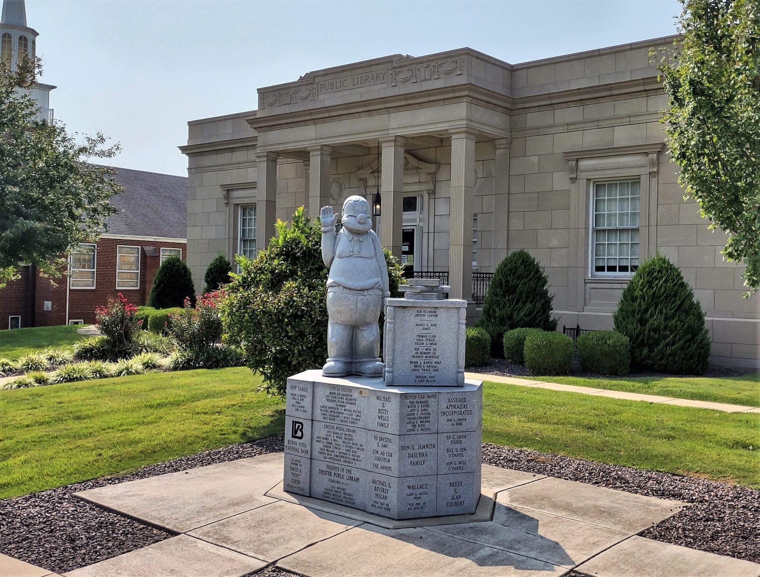 Photograph of a statue of Popeye cartoon character Cole Oyl on the grounds of Chester Public Library.