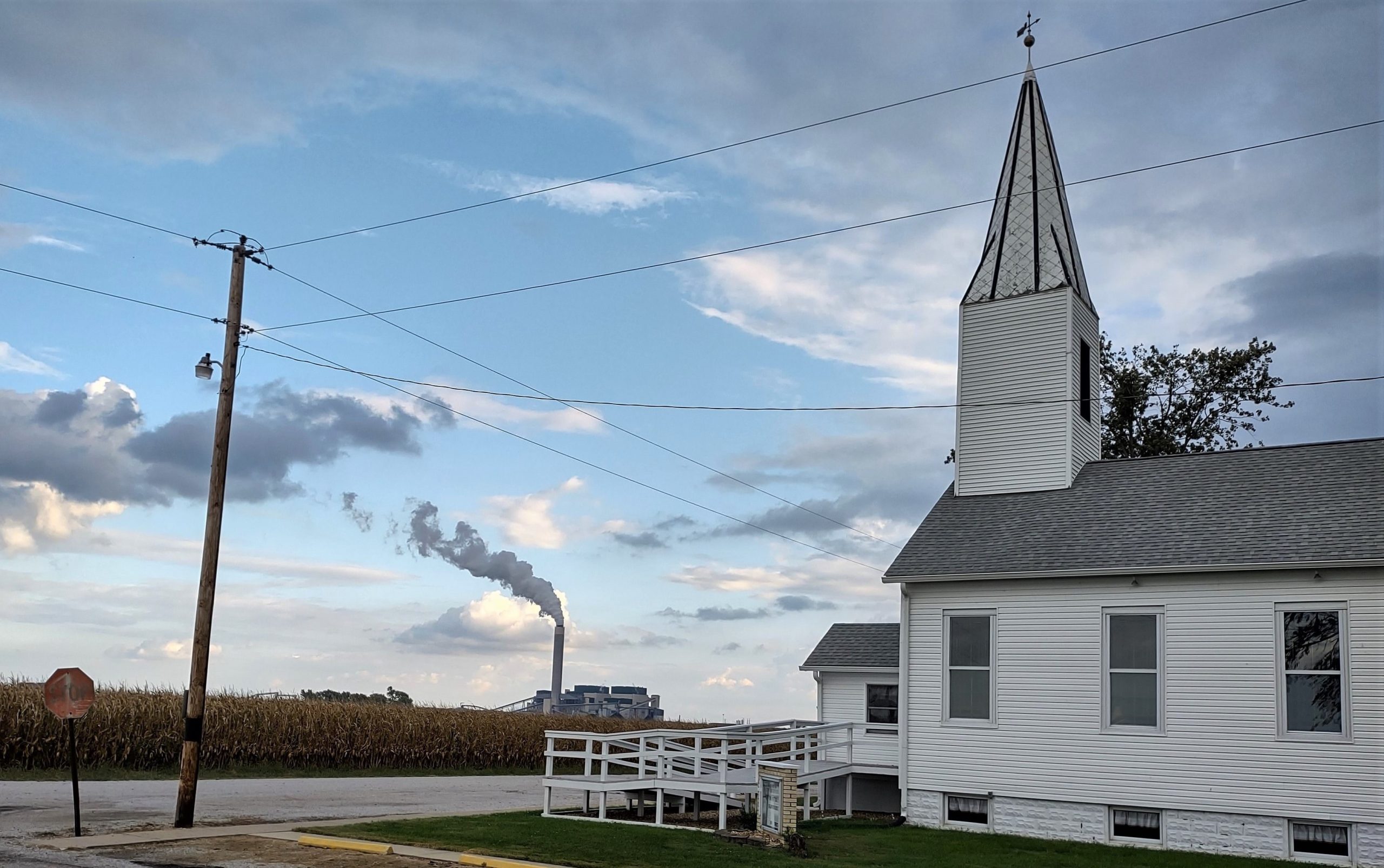 Photograph of Trinity United Church of Christ, Biddleborn (southwestern Washington County); cornfield; Prairie State Energy Campus in distance.