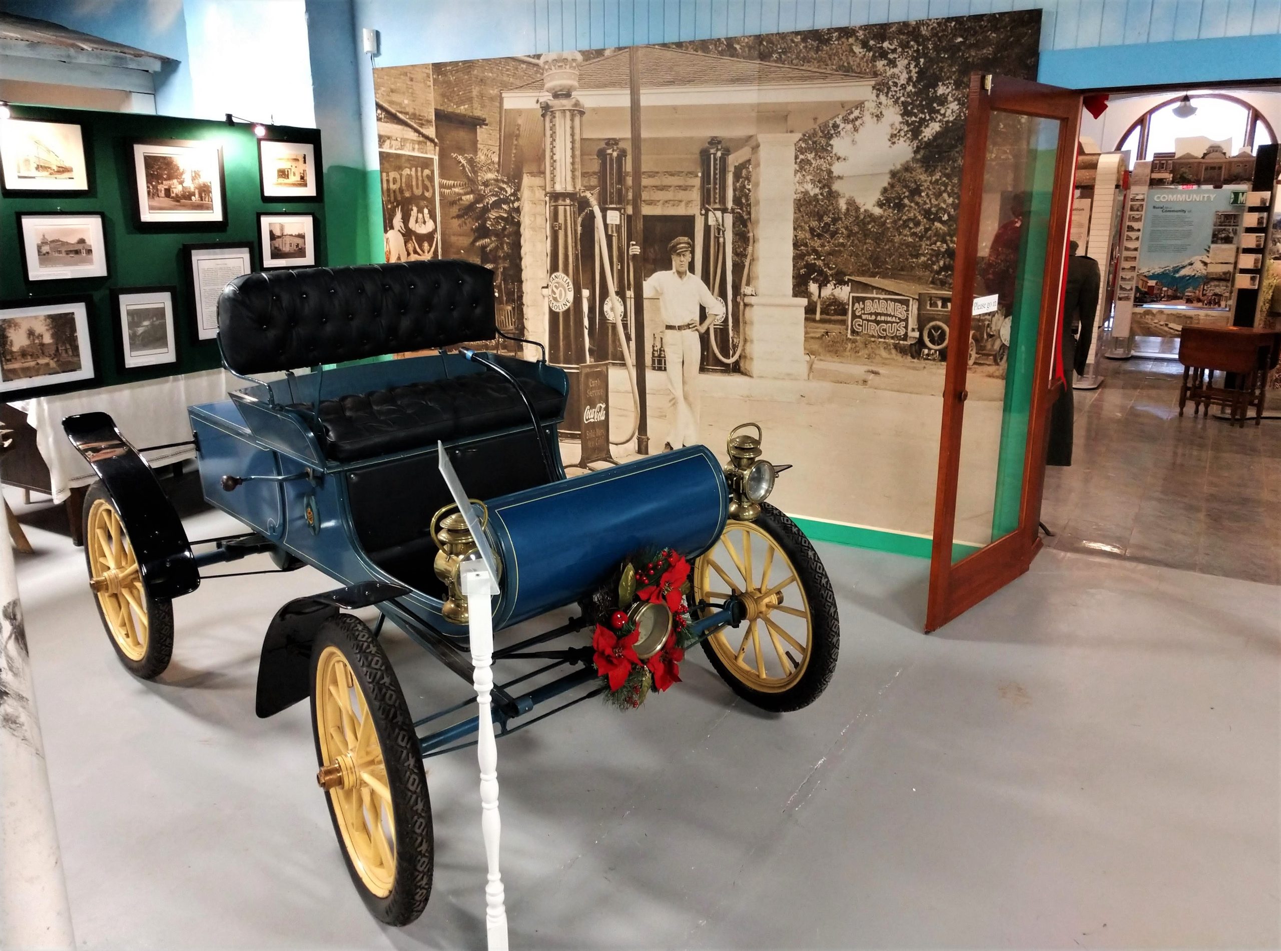 Photograph of vintage car and wall-size photograph of a filling station included in Old School Museum's companion exhibition.
