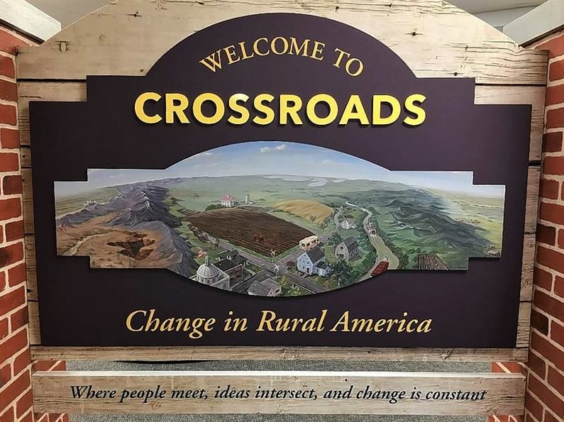 Photograph of "welcome" sign introducing Crossroads: Change in Rural America.