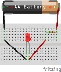A circuit installed on a tiny breadboard and powered by an AA battery.