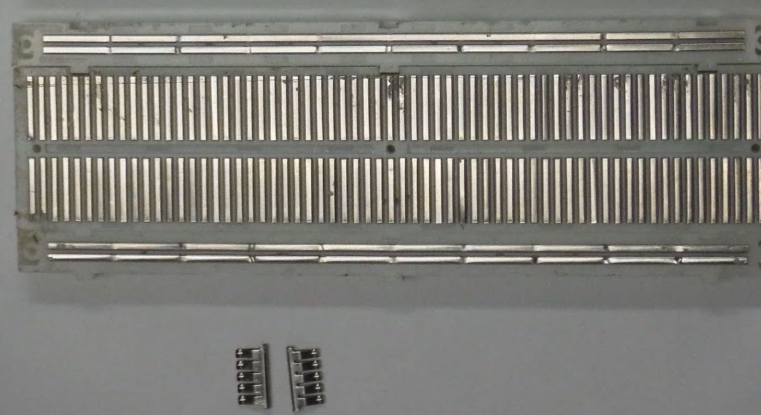 The bottom of a typical breadboard, with the sticky tape removed.