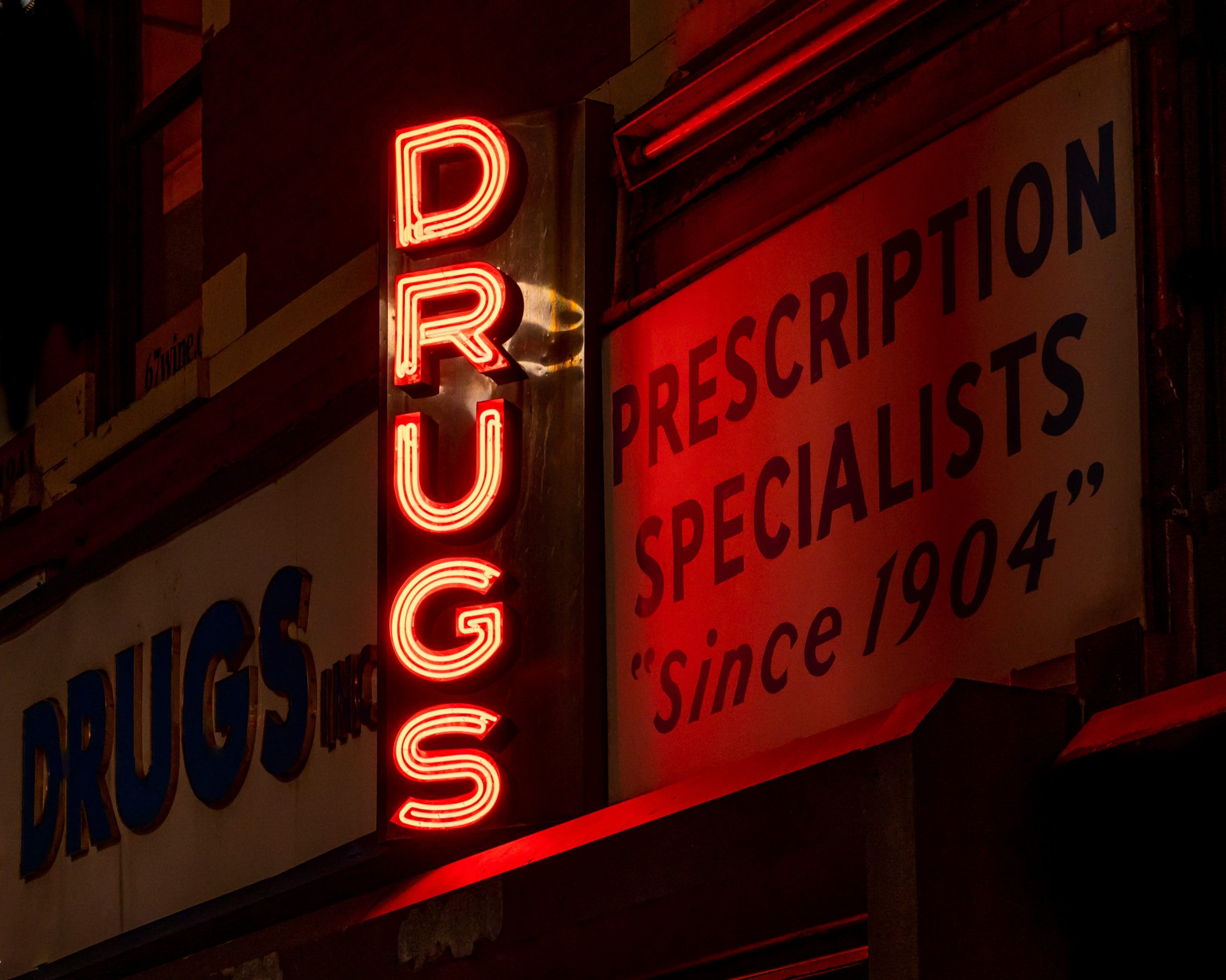 Neon sign of the word DRUGS