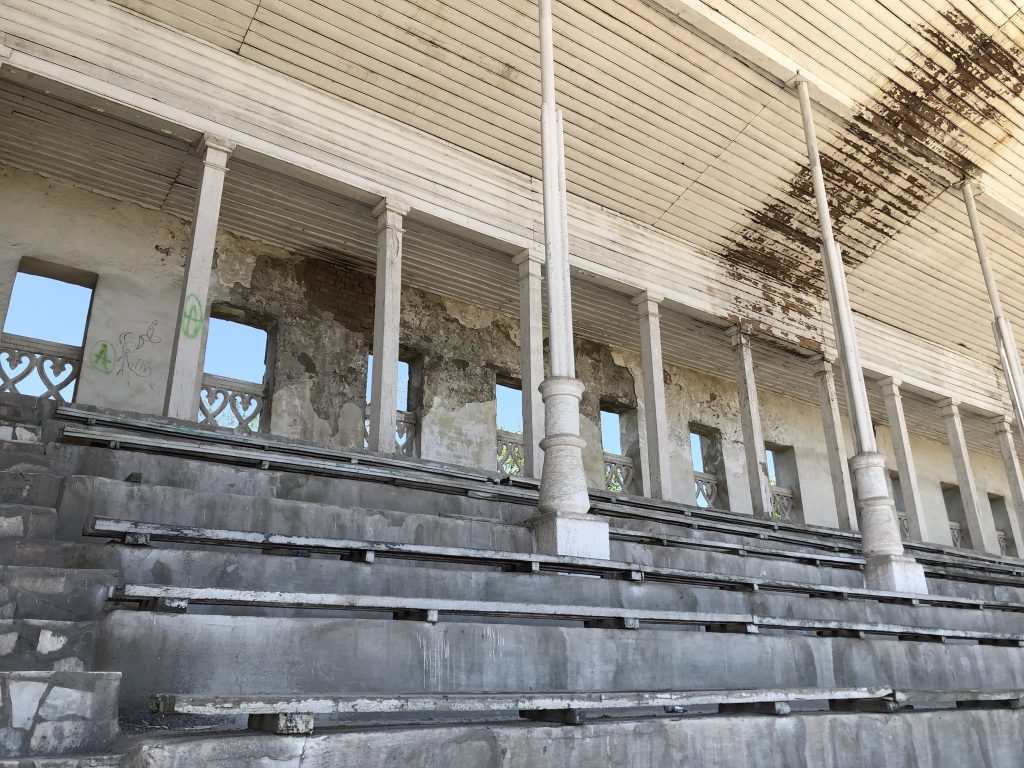 Covered and uncovered seats at the racetrack at the Ak-Kula Hippodrome, circa 2022. Today, the outdoor steps and seating area are in poor condition.